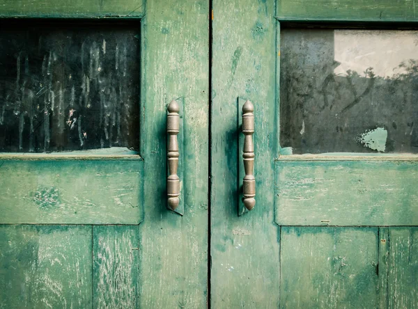Old wooden doors painted in green