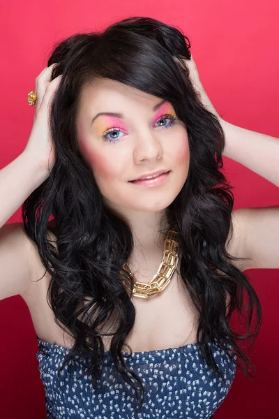 Beautiful girl with bright makeup and long curly hair