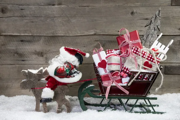 Elks pulling santa sleigh with presents