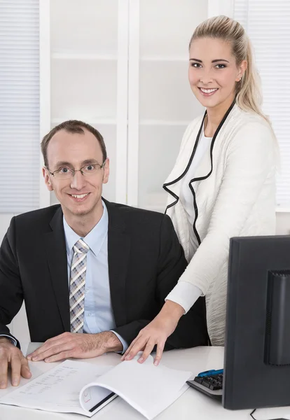Successful business team: smiling man and woman in portrait in t