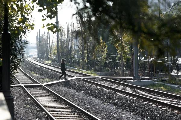 Woman cross the railway tracks