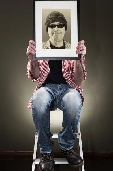 Man holding picture frame