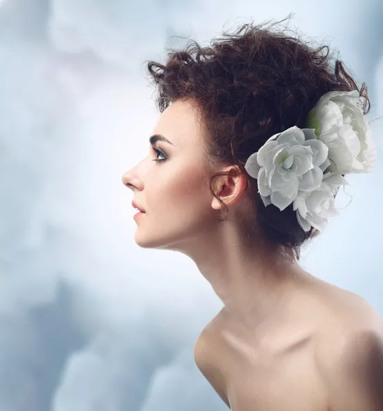 Fashion Beauty Model Girl with Flowers Hair. Bride.