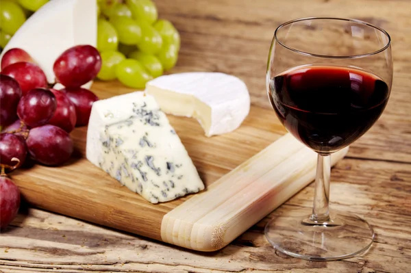 A red glass of wine and cheese