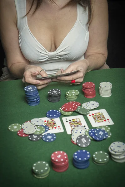 Very beautiful woman playing texas hold\'em poker