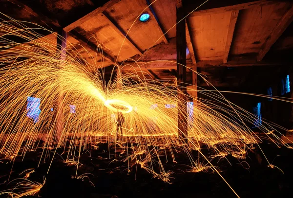 Man Spinning the Burning Steel Wool At Night