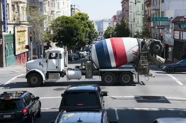 American concrete mixer truck is crossing a street in San Francisco