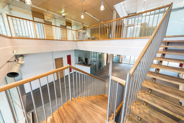 Stairway with wooden steps in modern office building