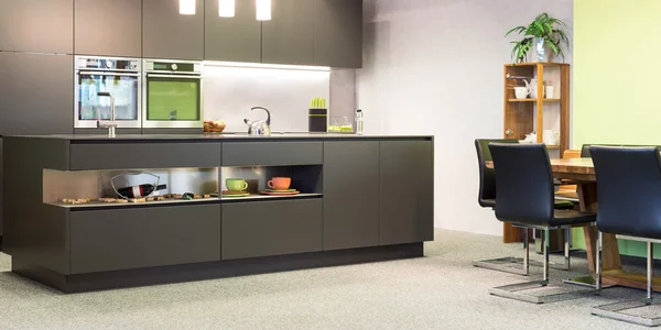 Modern dark grey kitchen with illumination and sitting suite
