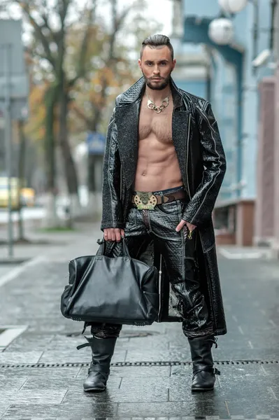 Stylish man with bag in a leather coat.