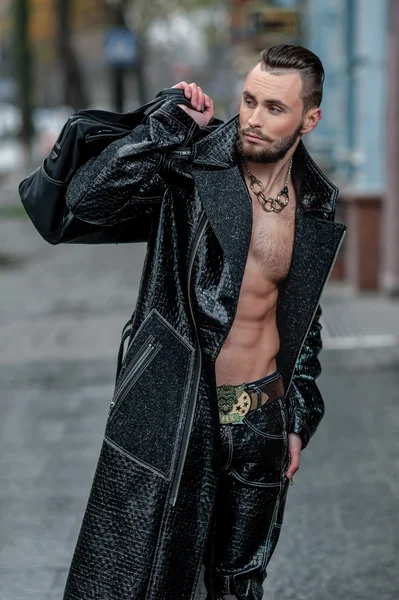 Stylish man with bag in a leather coat.