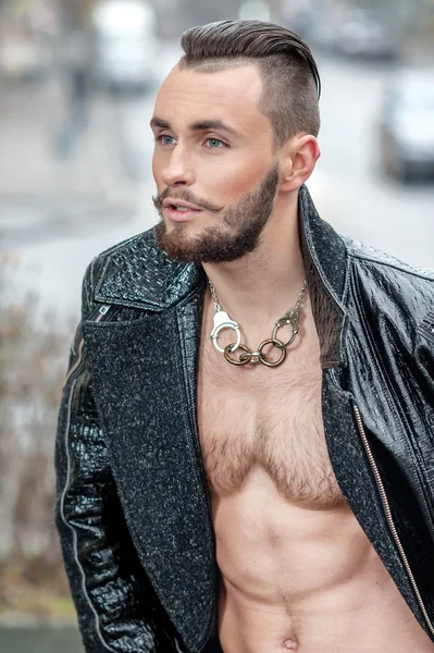 Man on the street in a leather coat.