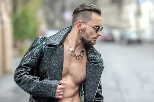 Man on the street in a leather coat.