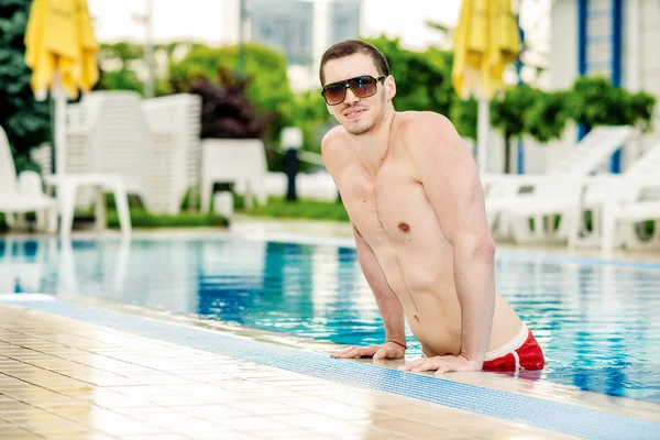 Guy standing in water in the pool