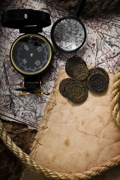Old compass, coins and rope