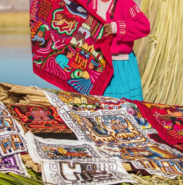 Woman preparing souvenirs in Uros, Peru, Bolivia.