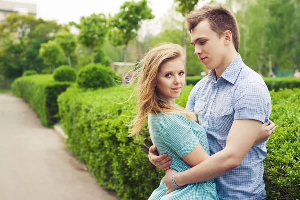 Beautiful couple on a date walking at the park. Copy space