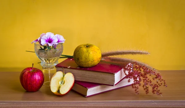 Book with flower and fruit