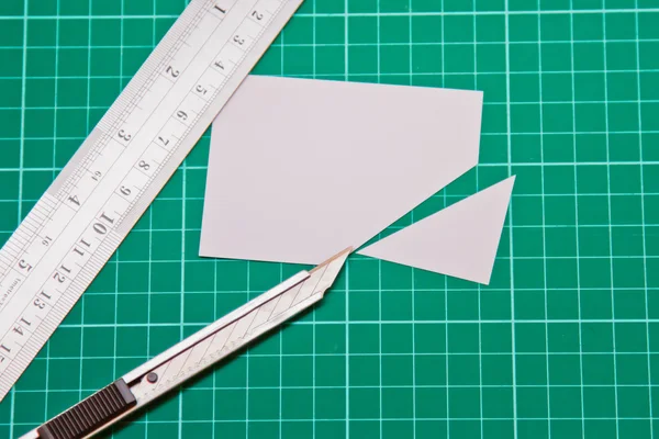 Cutter Knife Cutting white paper on cutting mat