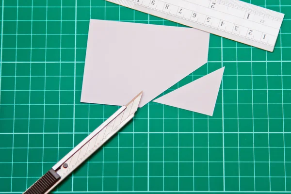 Cutter Knife Cutting white paper on cutting mat
