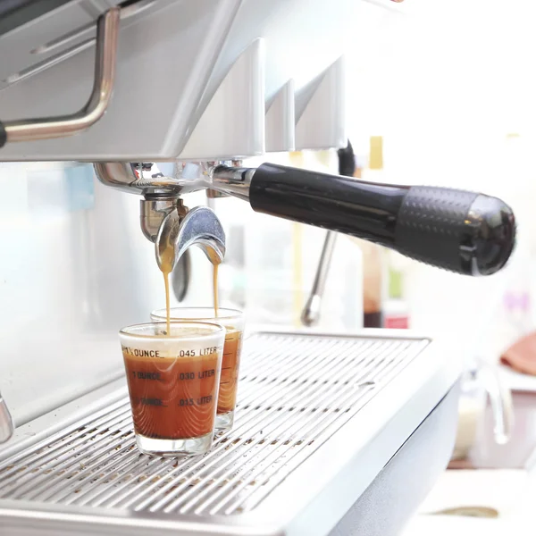 Prepares espresso in his coffee shop ,close-up