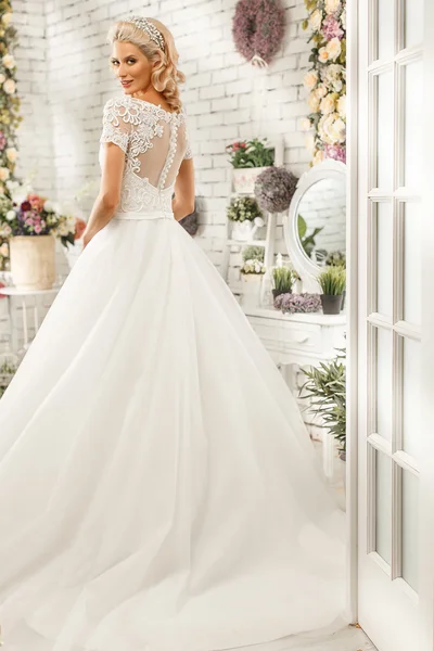The beautiful woman posing in a wedding dress