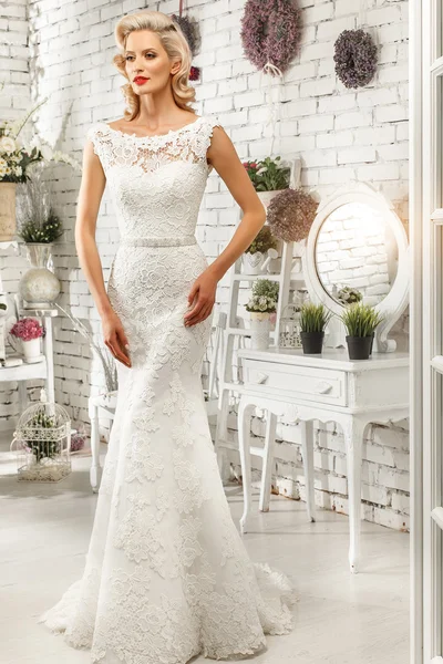 The beautiful  woman posing in a wedding dress