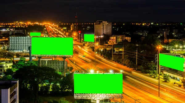 Top view of highway at night with green screen billboard