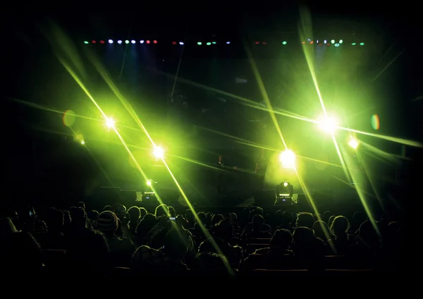 Stage with green light flares and audiences.