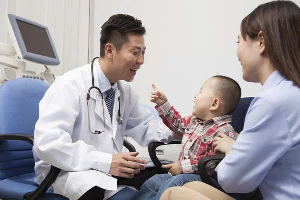 Baby Boy Playing With Doctor In Office