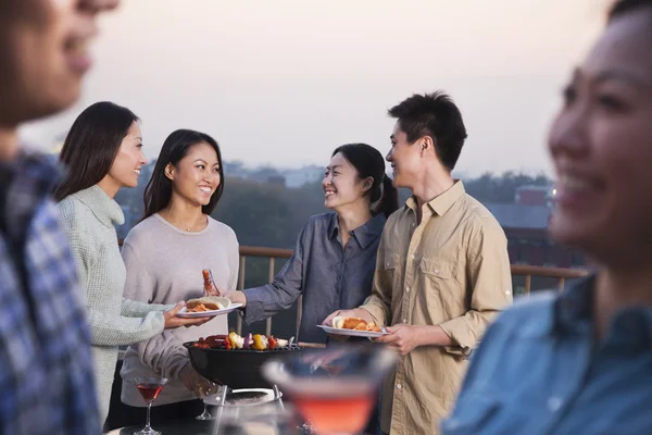 Group of Friends Having a Barbeque on a Rooftop