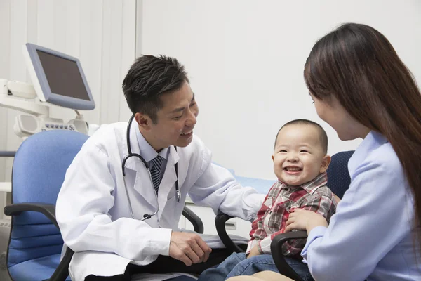 Baby Boy Playing With Doctor In Office