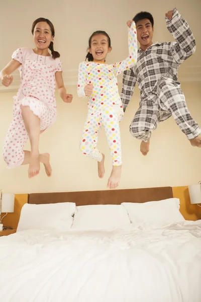 Family Jumping on Bed Together