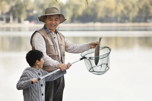 Grandfather and grandson fishing