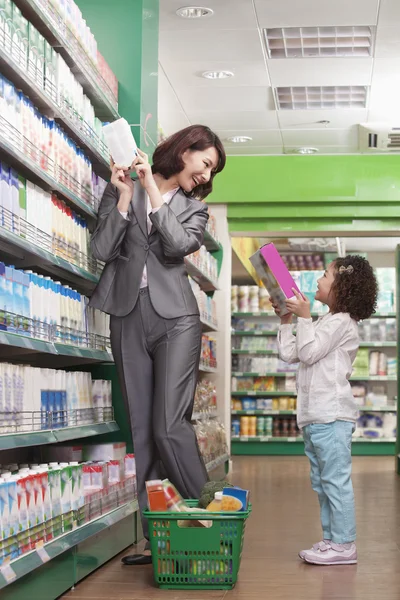 Mother and Daughter Having Fun in Supermarket