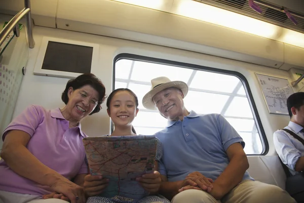 Granddaughter with grandparents in the subway