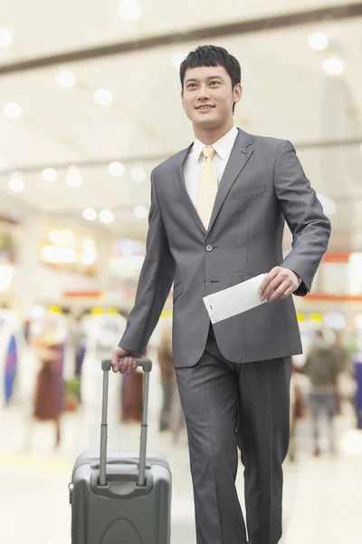 Business man walking with suitcase