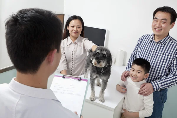 Family with pet dog in veterinarian\'s office