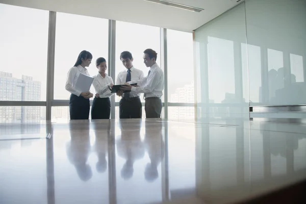 Business people standing by conference table