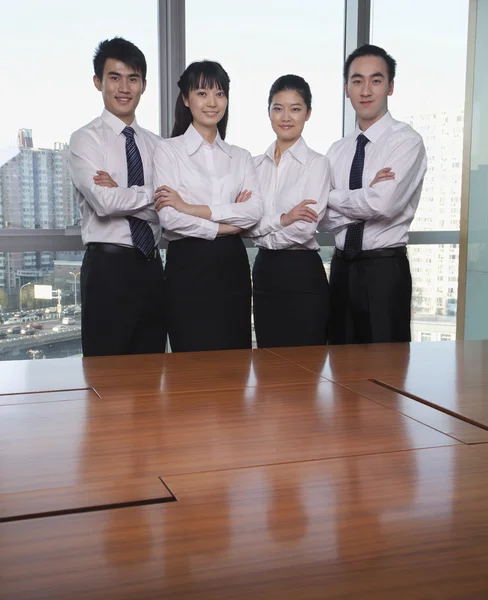 Young business people standing by conference table