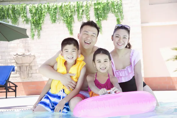 Family smiling by the pool