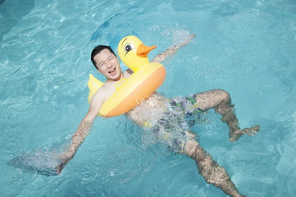 Man wearing a yellow duck inflatable tube