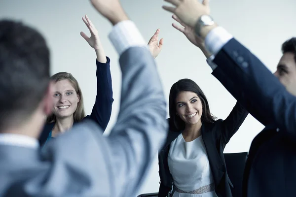 Business people cheering with hands together