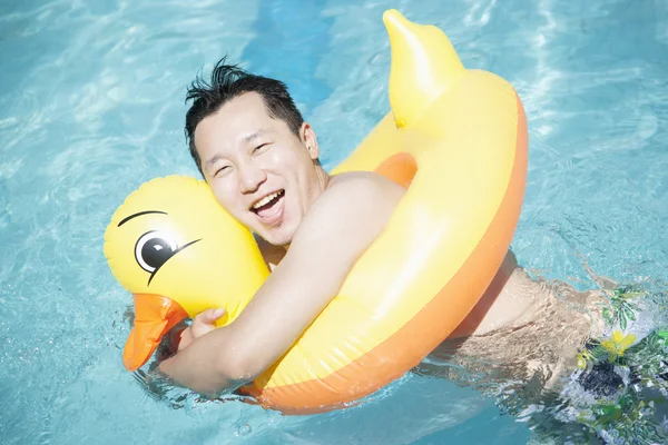 Man wearing a yellow duck inflatable tube