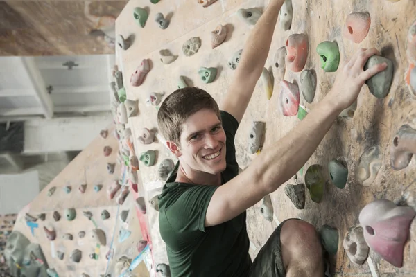 Man climbing up in an indoor climbing gym