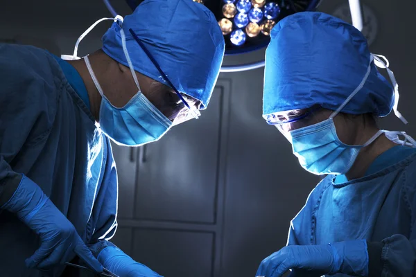 Two surgeons concentrating at the operating table