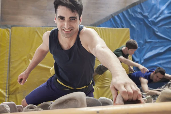 Man climbing up in an indoor climbing gym