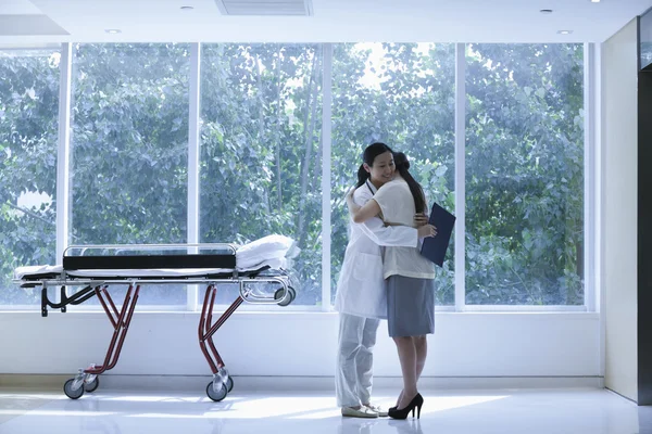 Doctor and patient hugging