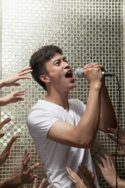 Man singing into a microphone