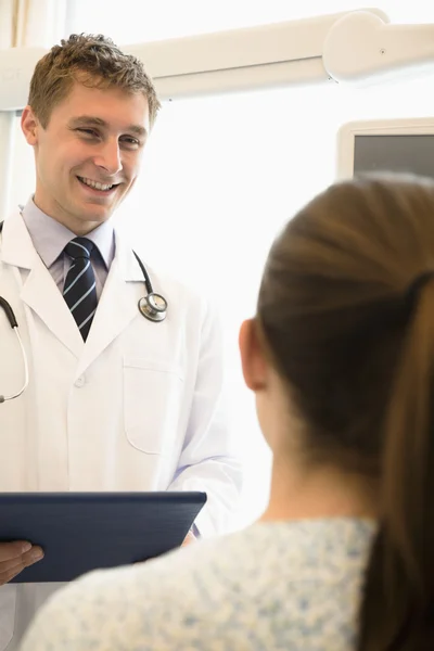 Doctor discussing medical chart with a patient
